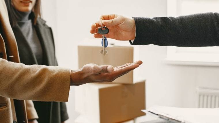Keys being handed over at a doorway